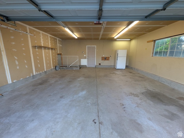 2826 W 4275 S, Roy, UT 84067 - garage featuring freestanding refrigerator and a garage door opener