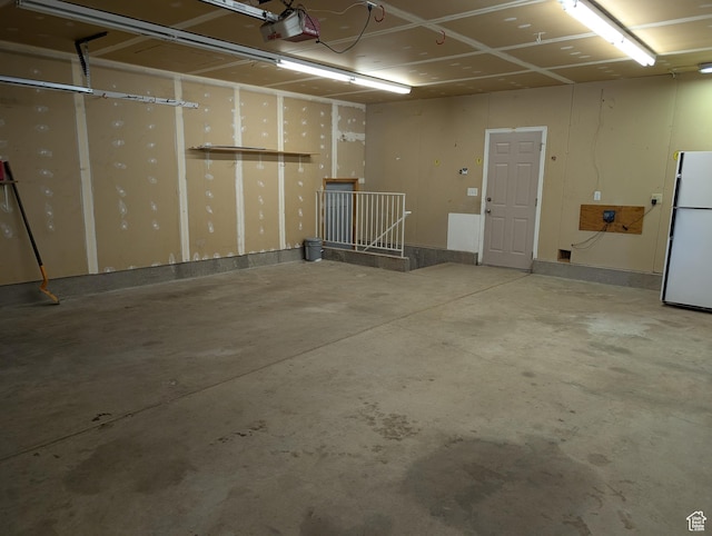 2826 W 4275 S, Roy, UT 84067 - garage featuring freestanding refrigerator and a garage door opener