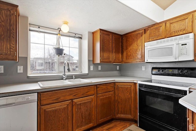 2826 W 4275 S, Roy, UT 84067 - kitchen with white appliances, light countertops, wood finished floors, and brown cabinets