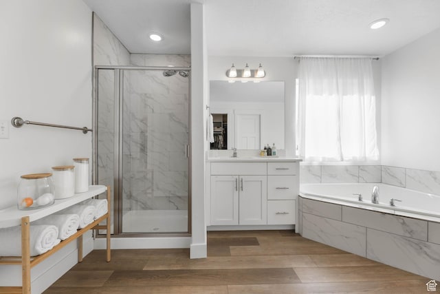 8151 St Cecilia St S, Eagle Mountain, UT 84005 - full bathroom featuring a marble finish shower, a bath, vanity, wood finished floors, and recessed lighting
