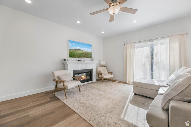 8151 St Cecilia St S, Eagle Mountain, UT 84005 - living room featuring recessed lighting, wood finished floors, ceiling fan, and a glass covered fireplace