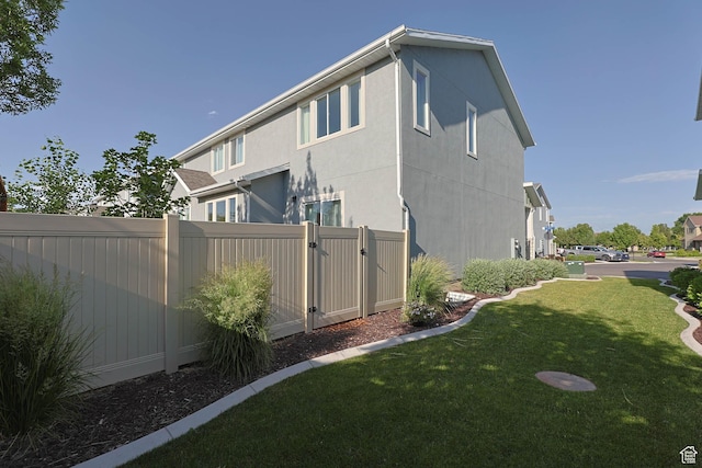 8151 St Cecilia St S, Eagle Mountain, UT 84005 - back of house featuring stucco siding and a gate