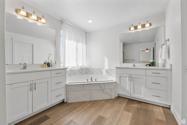 8151 St Cecilia St S, Eagle Mountain, UT 84005 - full bath featuring two vanities, a bath, wood finished floors, and a ceiling fan