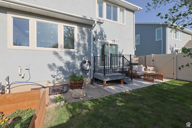 8151 St Cecilia St S, Eagle Mountain, UT 84005 - rear view of property featuring a gate, stucco siding, an outdoor hangout area, a patio area, and a deck