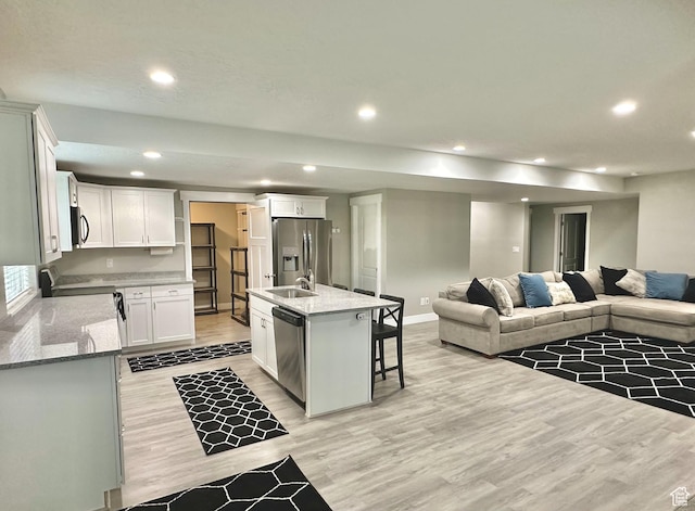 6057 W Herriman View Way, Herriman, UT 84096 - kitchen featuring appliances with stainless steel finishes, open floor plan, light wood finished floors, recessed lighting, and white cabinets