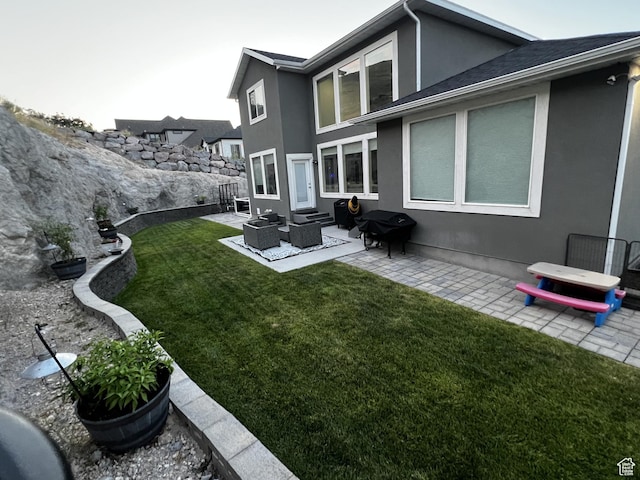 6057 W Herriman View Way, Herriman, UT 84096 - rear view of house with stucco siding, a patio, entry steps, and outdoor lounge area