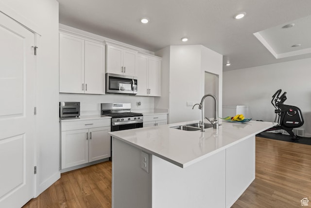 1268 S Raintree Ln, Santaquin, UT 84655 - kitchen featuring stainless steel appliances, wood finished floors, an island with sink, white cabinets, and recessed lighting