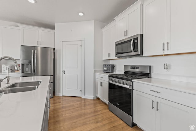 1268 S Raintree Ln, Santaquin, UT 84655 - kitchen with appliances with stainless steel finishes, light countertops, white cabinetry, recessed lighting, and light wood-style floors