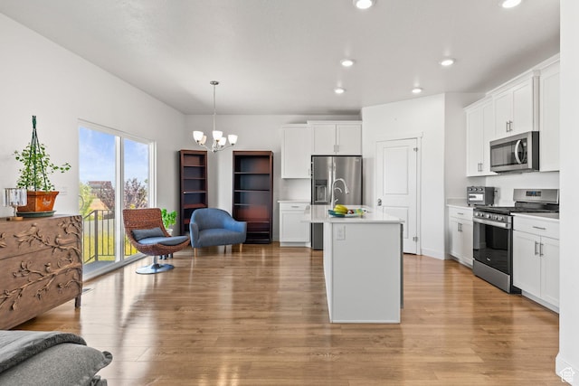 1268 S Raintree Ln, Santaquin, UT 84655 - kitchen with stainless steel appliances, recessed lighting, a chandelier, light countertops, and light wood-style flooring