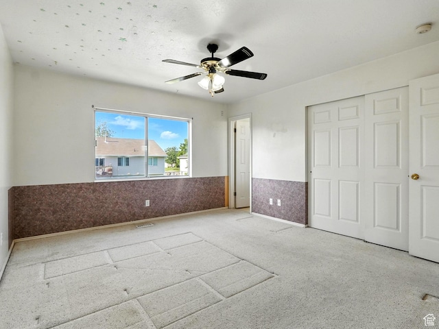 1213 W 1640 N, Clinton, UT 84015 - unfurnished bedroom featuring a wainscoted wall, a ceiling fan, and a closet