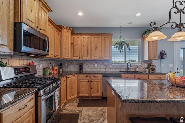 6613 W 200 N, Ogden, UT 84404 - kitchen with appliances with stainless steel finishes, decorative backsplash, dark stone counters, recessed lighting, and hanging light fixtures