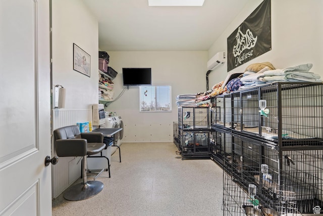 6613 W 200 N, Ogden, UT 84404 - office area featuring a wall unit AC, speckled floor, and washer / clothes dryer