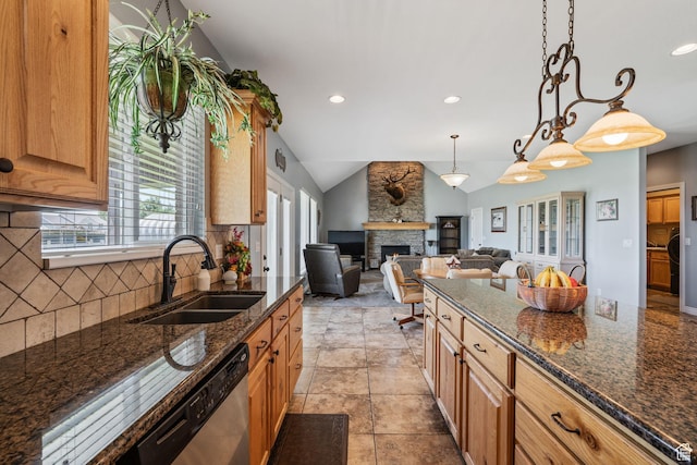 6613 W 200 N, Ogden, UT 84404 - kitchen with vaulted ceiling, a fireplace, backsplash, dark stone counters, and open floor plan