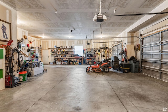 6613 W 200 N, Ogden, UT 84404 - garage featuring a garage door opener and a workshop area