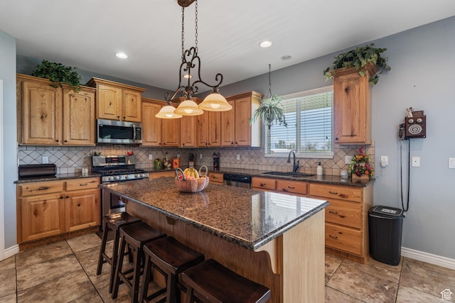 6613 W 200 N, Ogden, UT 84404 - kitchen with stainless steel appliances, decorative backsplash, a kitchen island, a breakfast bar area, and pendant lighting