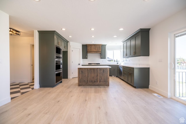 361 E Ventura Blvd, Tooele, UT 84074 - kitchen with stainless steel appliances, light wood-style flooring, recessed lighting, a center island, and light countertops