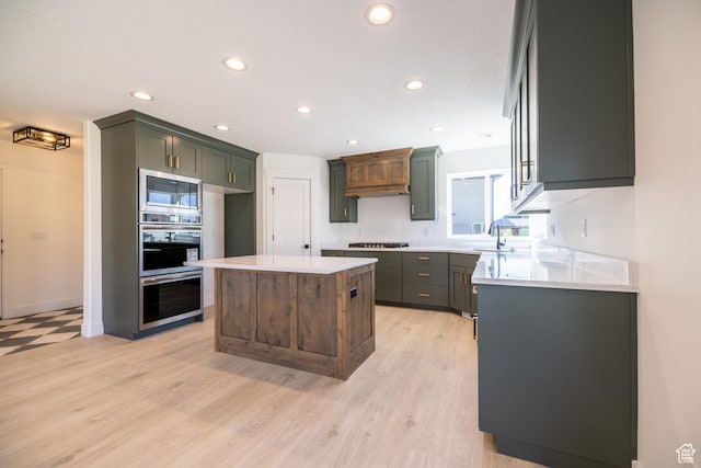 361 E Ventura Blvd, Tooele, UT 84074 - kitchen with appliances with stainless steel finishes, light countertops, recessed lighting, light wood finished floors, and a kitchen island