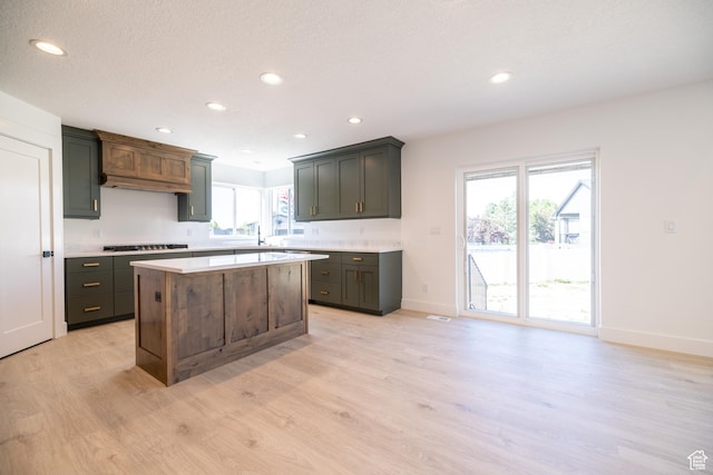 361 E Ventura Blvd, Tooele, UT 84074 - kitchen with light wood-style floors, gas stovetop, light countertops, recessed lighting, and a center island