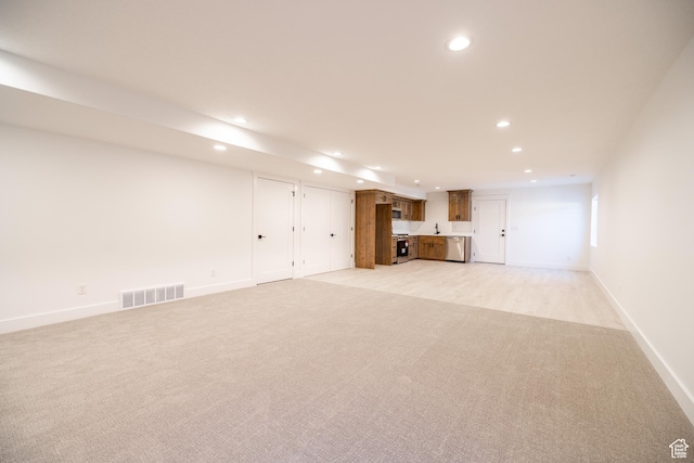 361 E Ventura Blvd, Tooele, UT 84074 - unfurnished living room featuring recessed lighting, light carpet, and bar with sink