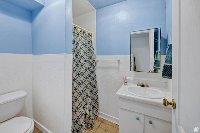 345 E 2475 N, North Logan, UT 84341 - bathroom with vanity, tile walls, wainscoting, and curtained shower