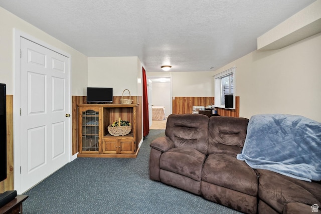 345 E 2475 N, North Logan, UT 84341 - carpeted living area featuring a textured ceiling, wainscoting, and wood walls