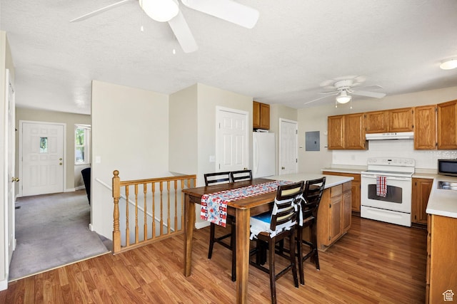 345 E 2475 N, North Logan, UT 84341 - kitchen featuring white appliances, ceiling fan, light countertops, light wood-style flooring, and under cabinet range hood