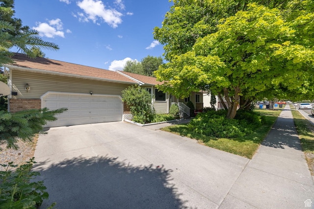 345 E 2475 N, North Logan, UT 84341 - view of front facade with a garage, driveway, and brick siding