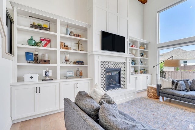 953 E 1000 N, American Fork, UT 84003 - living area with light wood-style flooring, a tile fireplace, and built in shelves