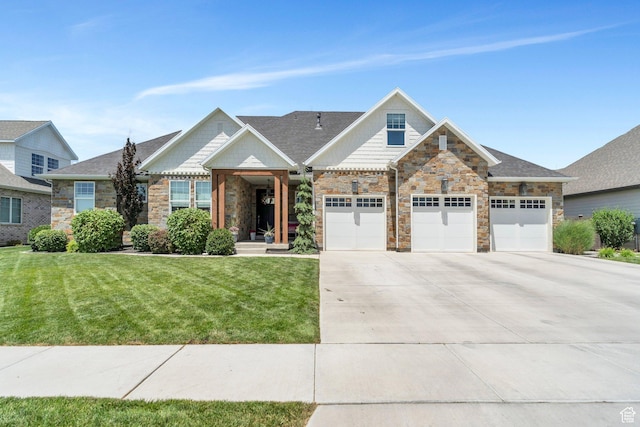 953 E 1000 N, American Fork, UT 84003 - view of front of home with stone siding, concrete driveway, and a front lawn