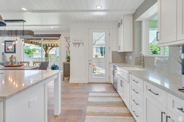 953 E 1000 N, American Fork, UT 84003 - kitchen featuring light wood-type flooring, decorative backsplash, a wooden ceiling with exposed beams, white cabinets, and stainless steel dishwasher