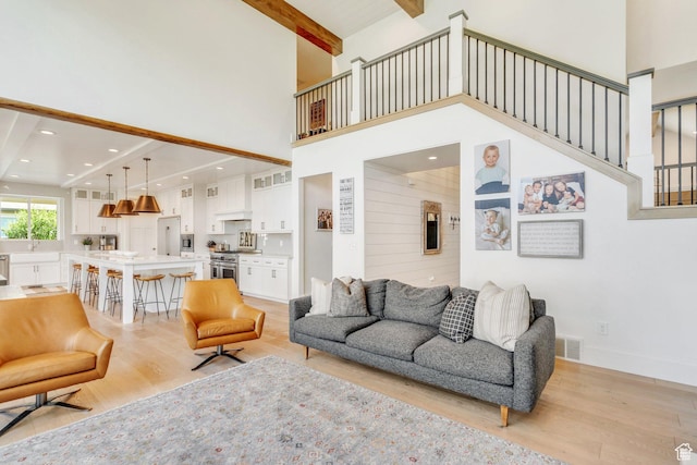 953 E 1000 N, American Fork, UT 84003 - living area with light wood-style floors, a high ceiling, beamed ceiling, stairs, and recessed lighting