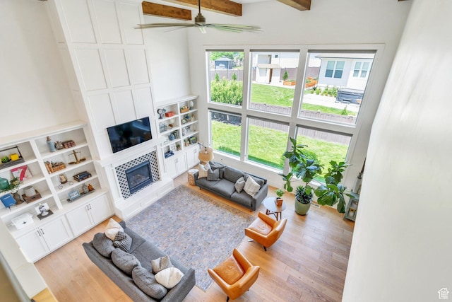 953 E 1000 N, American Fork, UT 84003 - living room featuring plenty of natural light, a tiled fireplace, light wood-style floors, a ceiling fan, and beam ceiling