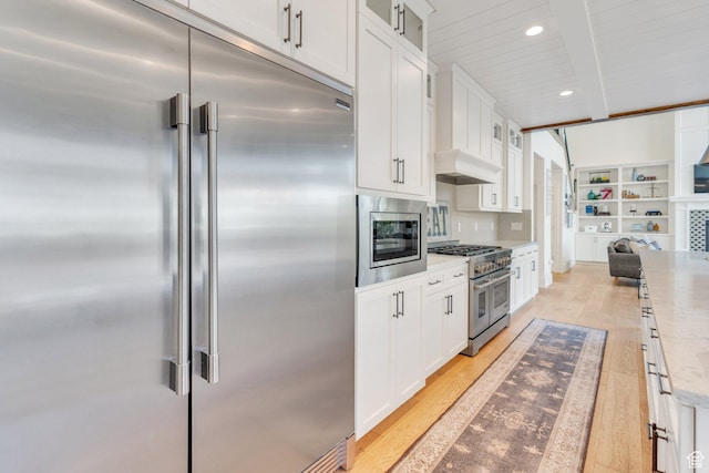953 E 1000 N, American Fork, UT 84003 - kitchen featuring built in appliances, beamed ceiling, light wood finished floors, white cabinets, and glass insert cabinets