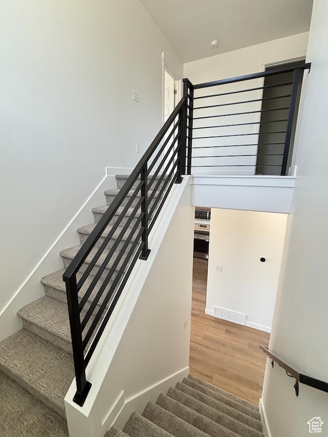 4683 S Roger View Ln W Unit 7, West Valley City, UT 84120 - stairs featuring wood finished floors and baseboards