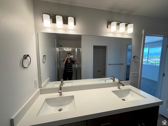 4683 S Roger View Ln W Unit 7, West Valley City, UT 84120 - bathroom featuring a shower stall and double vanity