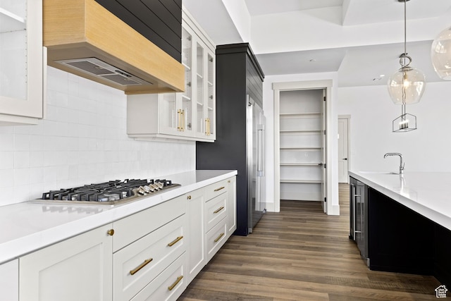 4982 W 3175 S, Hurricane, UT 84737 - kitchen with extractor fan, stainless steel gas stovetop, light countertops, glass insert cabinets, and backsplash