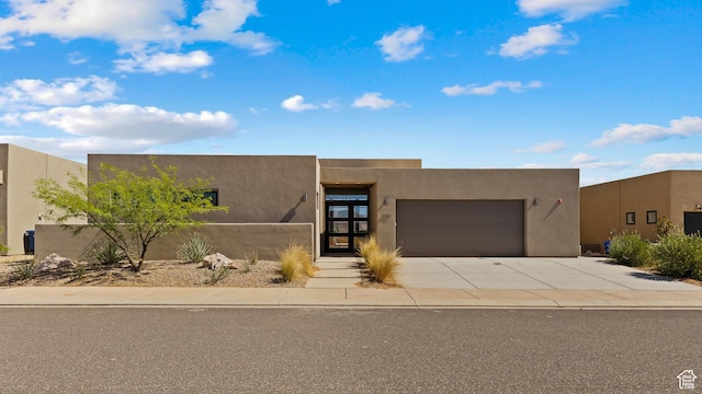 4982 W 3175 S, Hurricane, UT 84737 - pueblo-style home featuring an attached garage, concrete driveway, and stucco siding