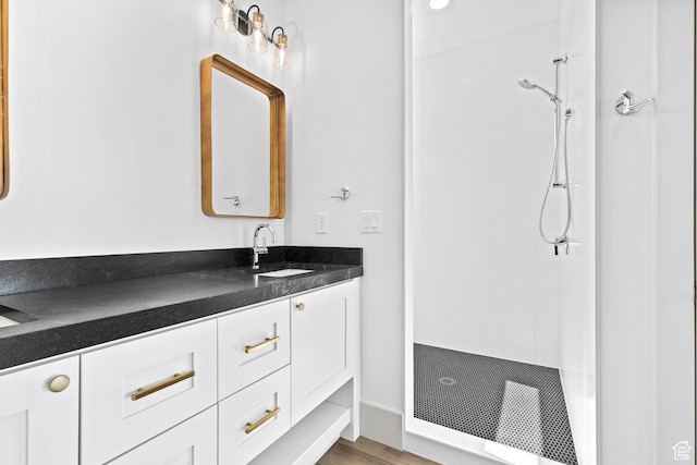 4982 W 3175 S, Hurricane, UT 84737 - full bathroom with tiled shower, vanity, and wood finished floors