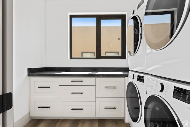 4982 W 3175 S, Hurricane, UT 84737 - washroom featuring stacked washer and clothes dryer, cabinet space, and wood finished floors