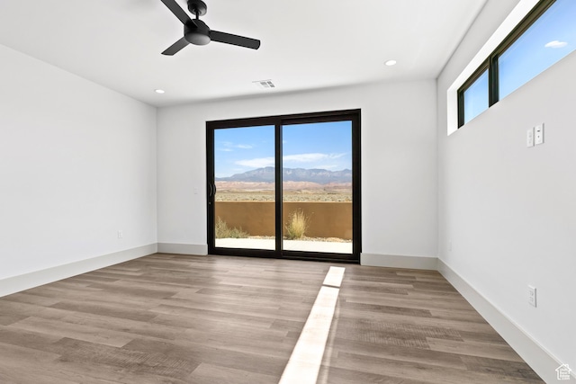 4982 W 3175 S, Hurricane, UT 84737 - unfurnished room featuring a ceiling fan, recessed lighting, wood finished floors, and a mountain view