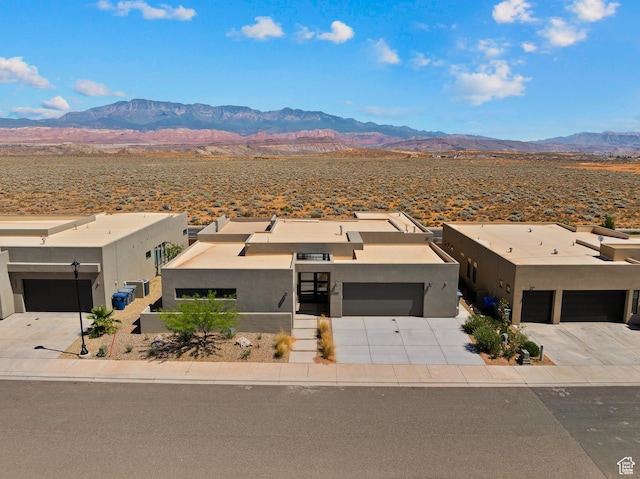 4982 W 3175 S, Hurricane, UT 84737 - view of front of house featuring a mountain view, stucco siding, and driveway