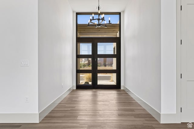 4982 W 3175 S, Hurricane, UT 84737 - entryway featuring a chandelier, wood finished floors, plenty of natural light, and a wall of windows