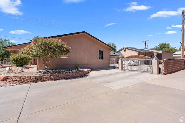 143 E 200 S, St George, UT 84770 - view of home's exterior featuring a gate and concrete driveway