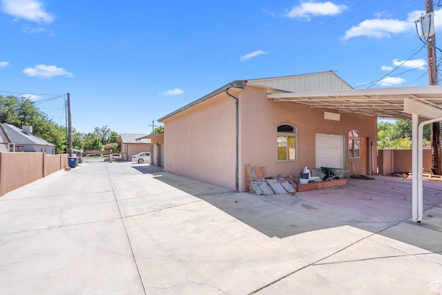 143 E 200 S, St George, UT 84770 - view of side of home with concrete driveway, stucco siding, and an attached carport