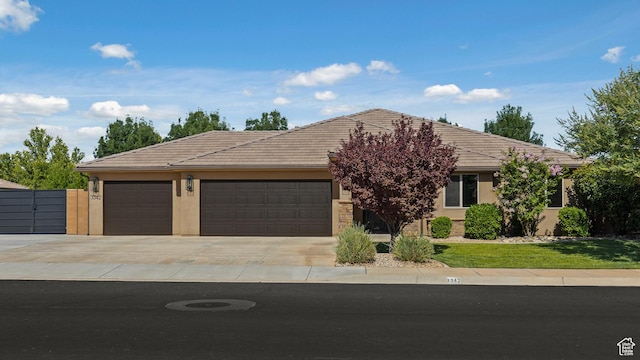 3342 S 240 W, Washington, UT 84780 - view of front of property featuring concrete driveway, an attached garage, a tile roof, and stucco siding