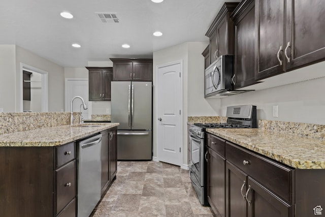 3342 S 240 W, Washington, UT 84780 - kitchen featuring stainless steel appliances, dark brown cabinetry, light stone counters, stone finish flooring, and recessed lighting