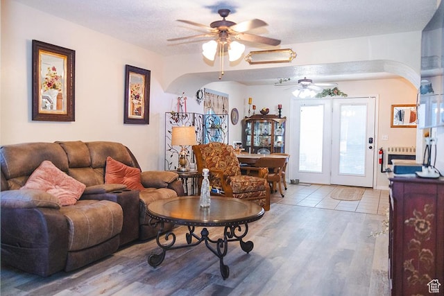 435 W Cobblestone Dr, Providence, UT 84332 - living room featuring ceiling fan, light wood-style flooring, and arched walkways