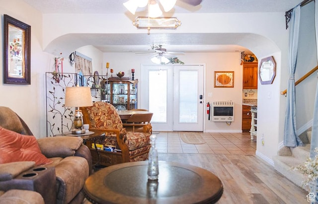 435 W Cobblestone Dr, Providence, UT 84332 - living area featuring heating unit, arched walkways, ceiling fan, stairs, and light wood-type flooring