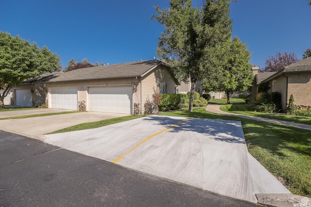 435 W Cobblestone Dr, Providence, UT 84332 - view of front of home featuring a front lawn, concrete driveway, and an attached garage