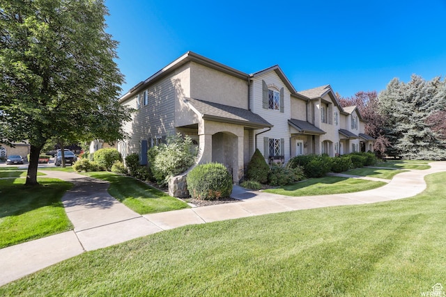 435 W Cobblestone Dr, Providence, UT 84332 - view of front of property featuring a front lawn and stucco siding
